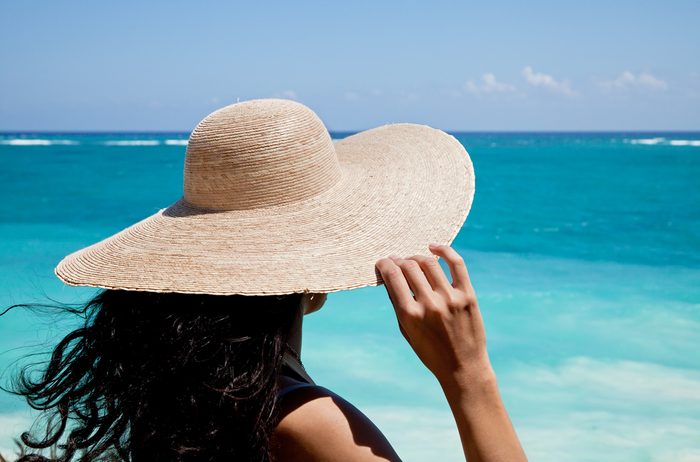 Young woman enjoying the ocean’s view in a summer vacation.
