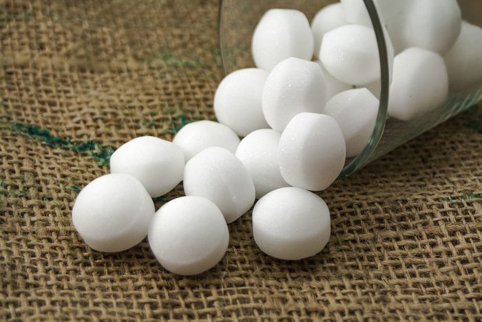 Moth balls in the glass over the sackcloth.