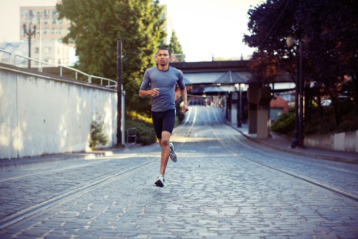man running for exercise through the city