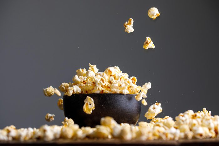 popped popcorn in a bowl and scattered on a table