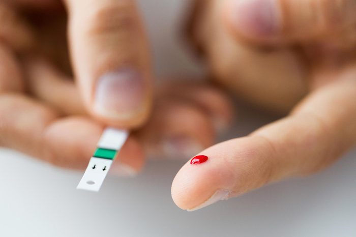 Close up a finger prick with drop of blood