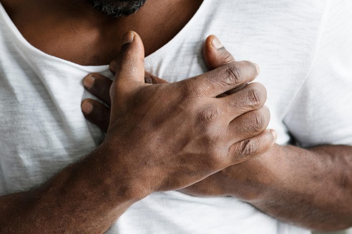 close up of man clutching his chest