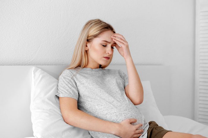 Pregnant woman lying in bed