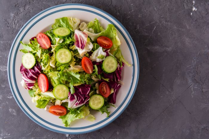 Fresh salad with tomato, cucumber and greens mixed.