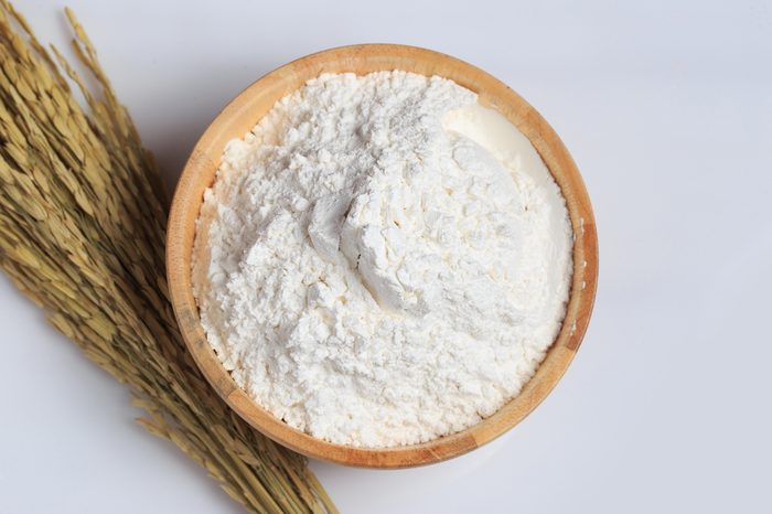 Rice powder in wooden bowl on white table
