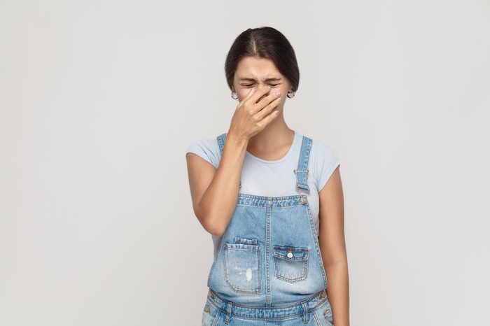 Distressed young woman with pinched face.