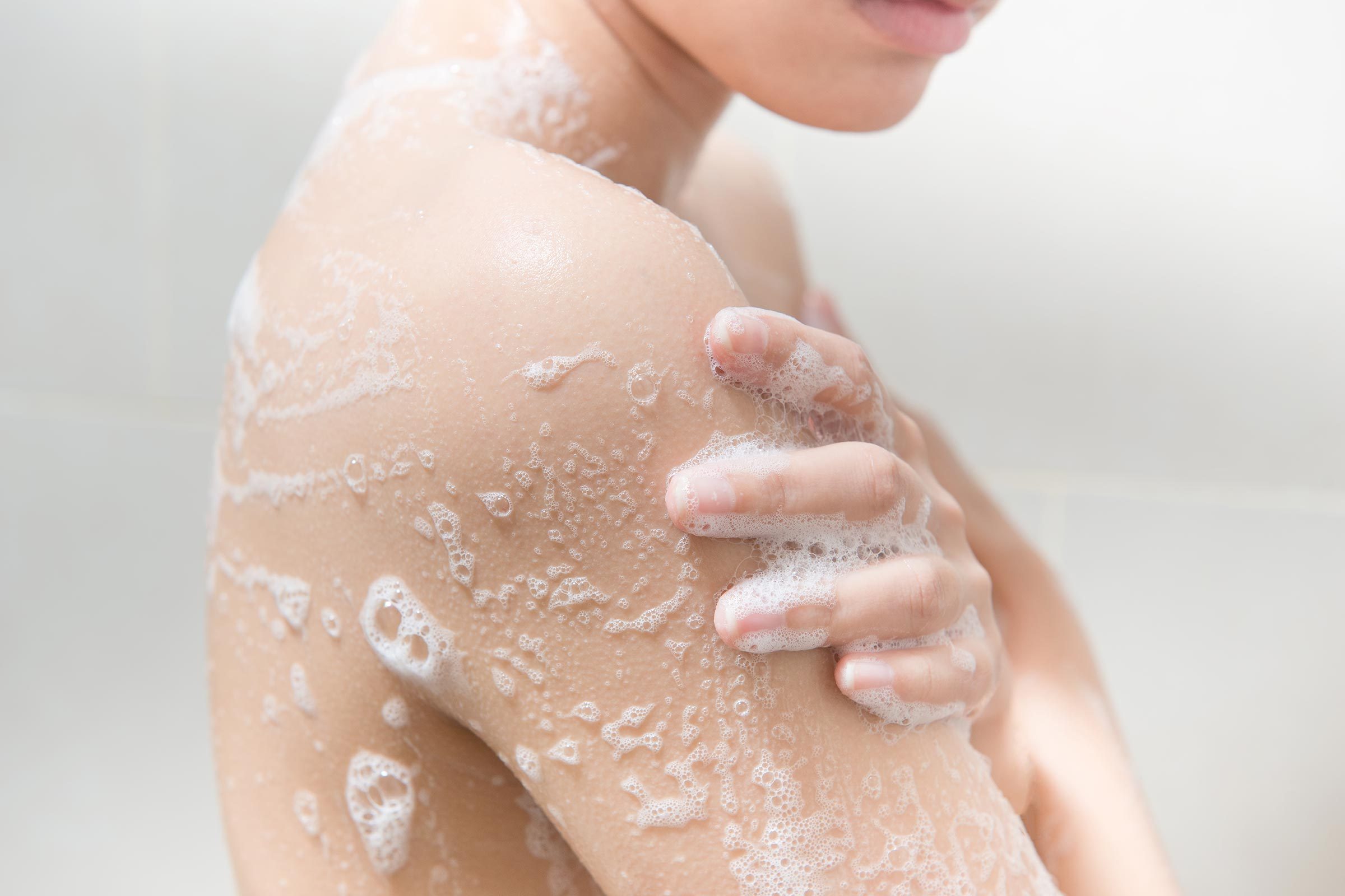 Woman showering and soaping up