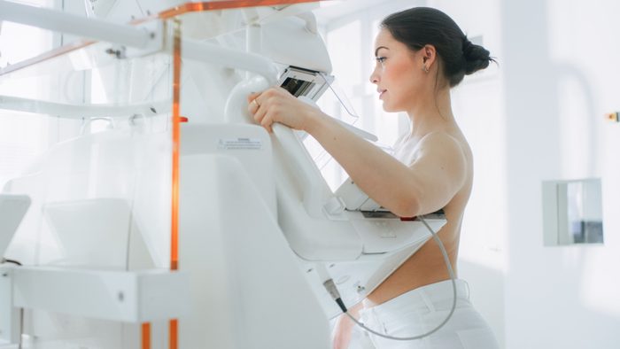 In the Hospital, Portrait Shot of Topless Female Patient Undergoing Mammogram Screening Procedure. Healthy Young Female Does Cancer Preventive Mammography Scan. Modern Hospital with High Tech Machines