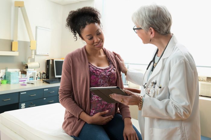 pregnant woman talking with doctor