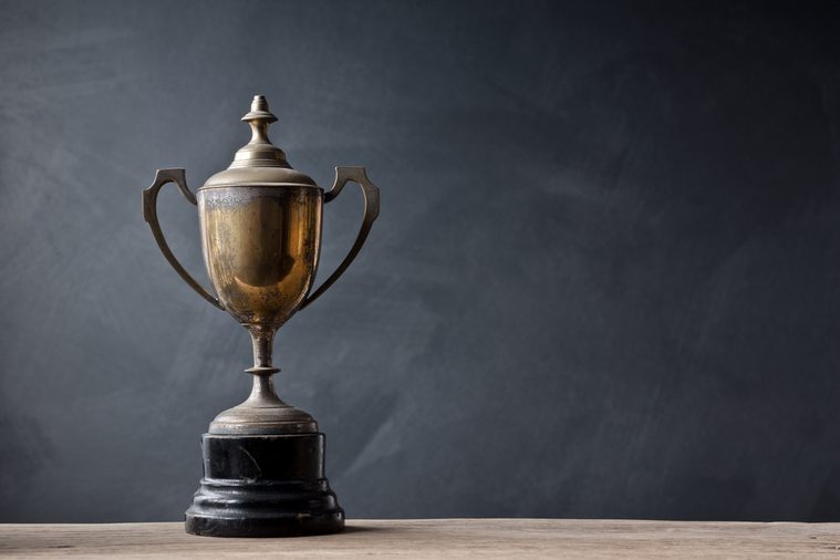 Old trophy in front of a black chalkboard
