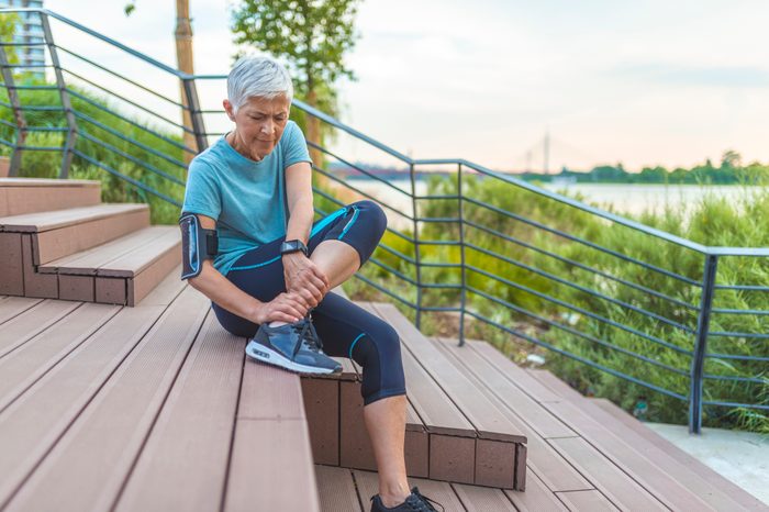 woman with sore ankle during workout