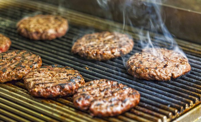 Preparing hamburgers on a grill