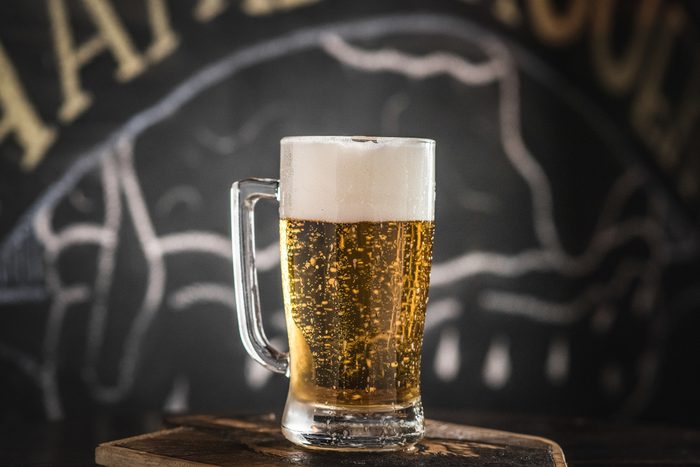 mug full of chopp, with chopp pilsen on a rustic table