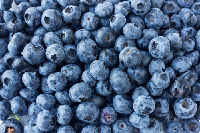 Fresh Blueberry Background. Texture blueberry berries close up. Various fresh summer berries. Top view.