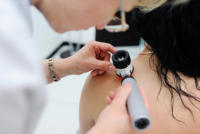 doctor examining woman's back