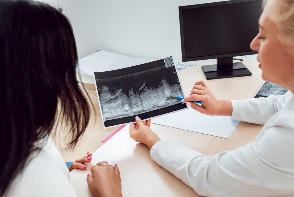 Doctor get examining breast of young woman. Consultation with gynecologist. Diagnostic, healthcare, medical service