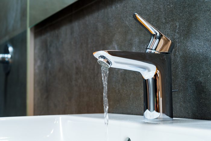 water running from faucet into sink