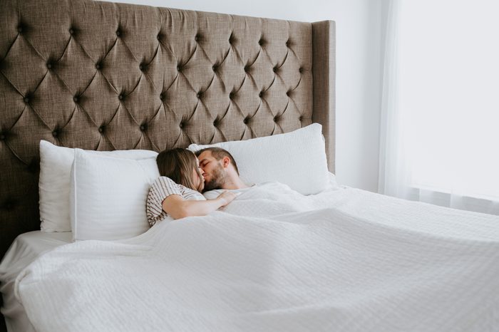Happy Couple in Cuddling in Bed