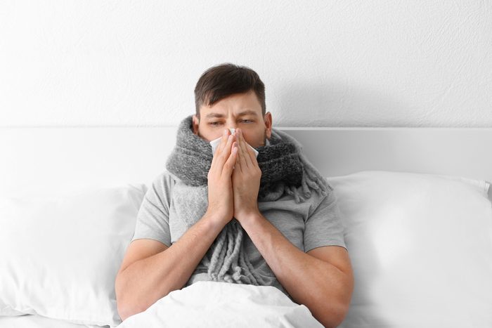 Young ill man in bed at home