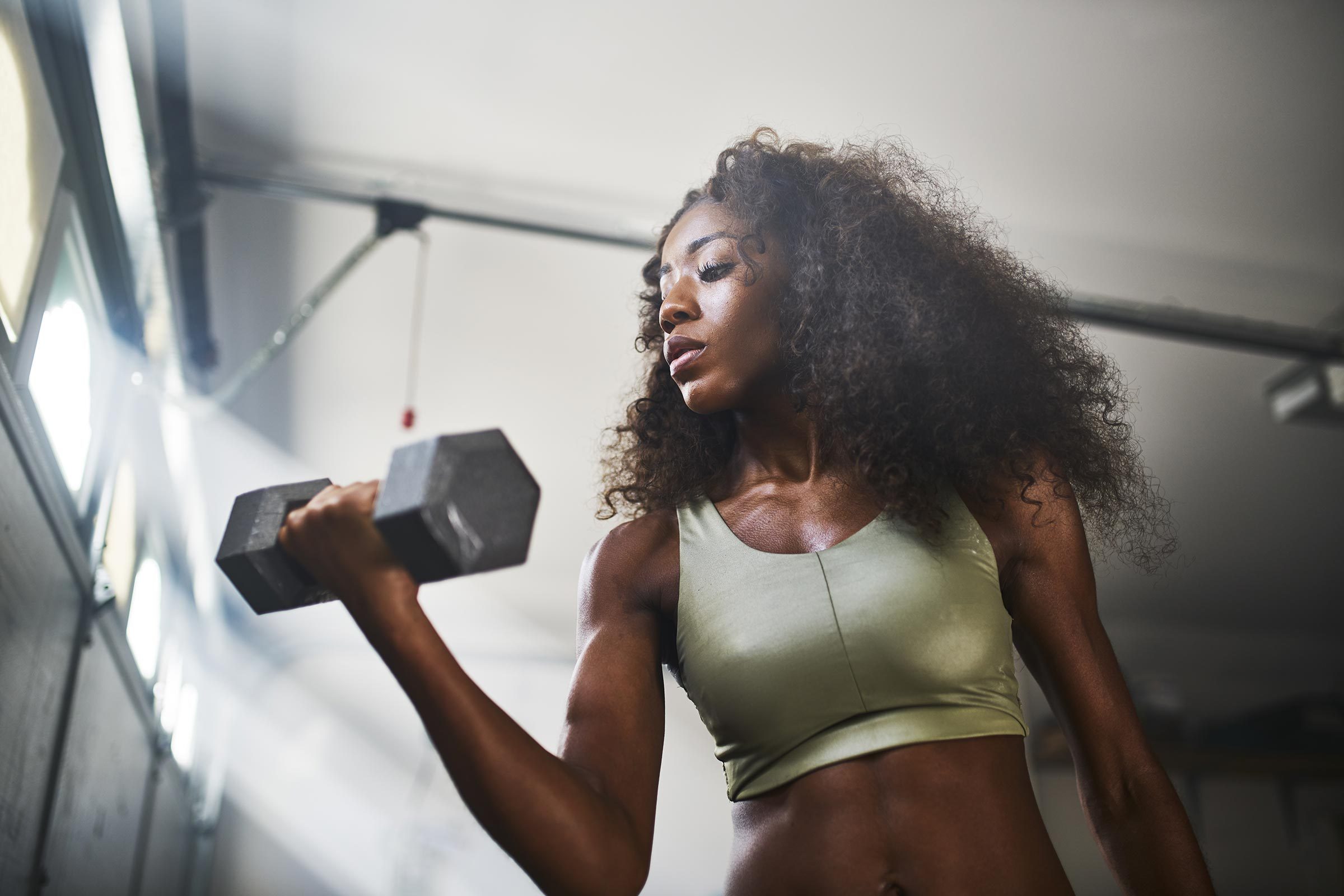 woman doing a bicep curl with weight