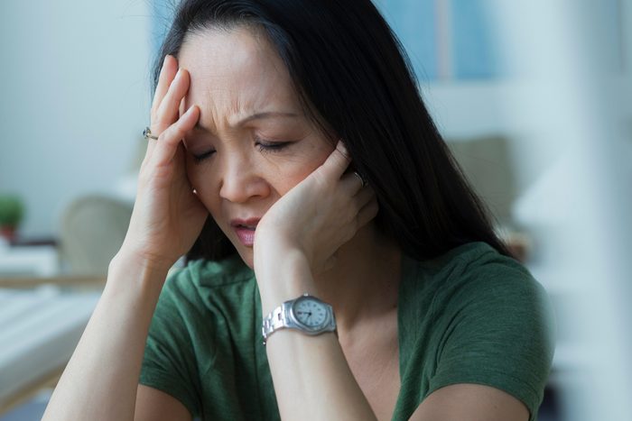 worried woman taking a deep breath