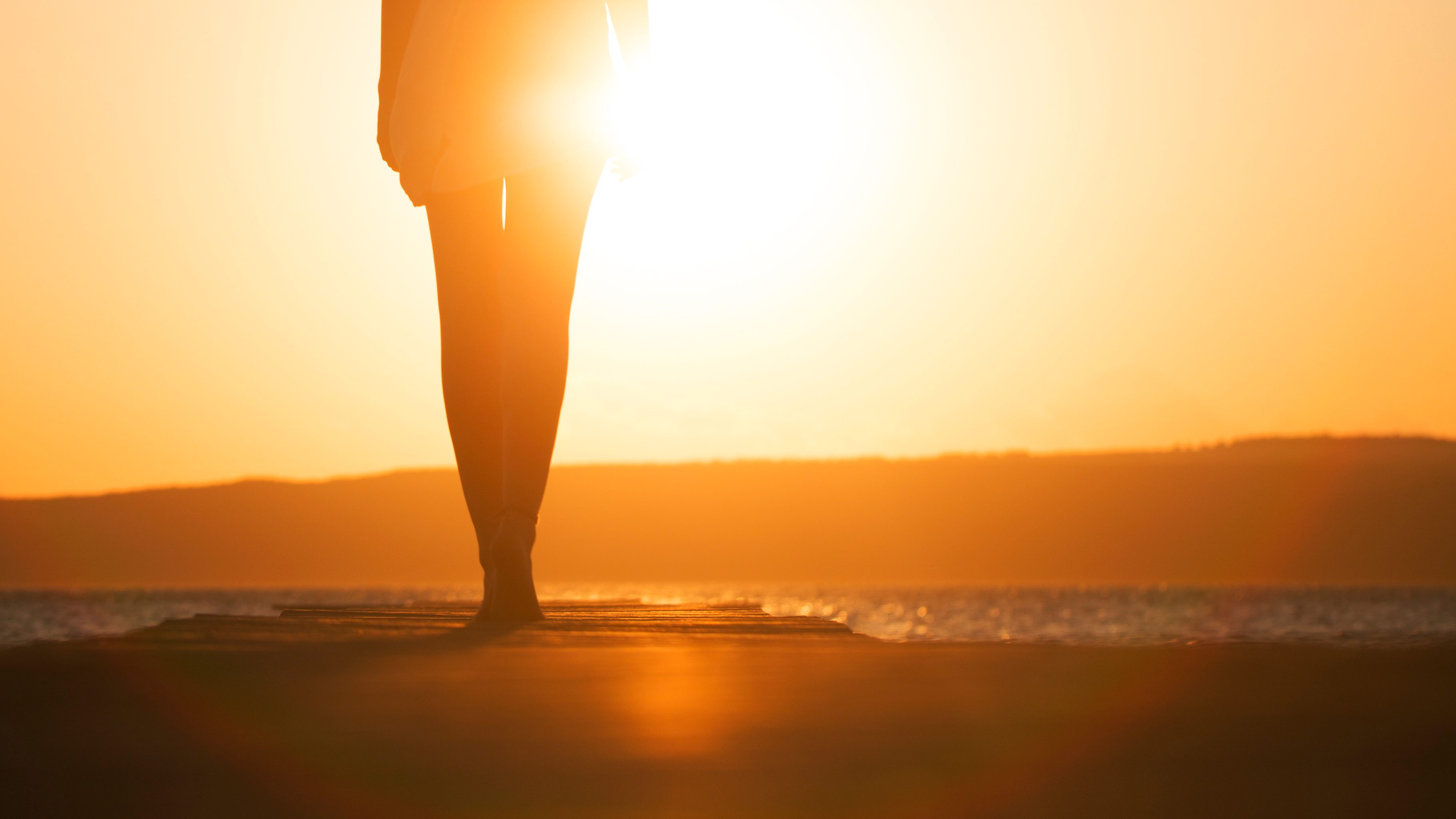 young woman's silhouette at sunset