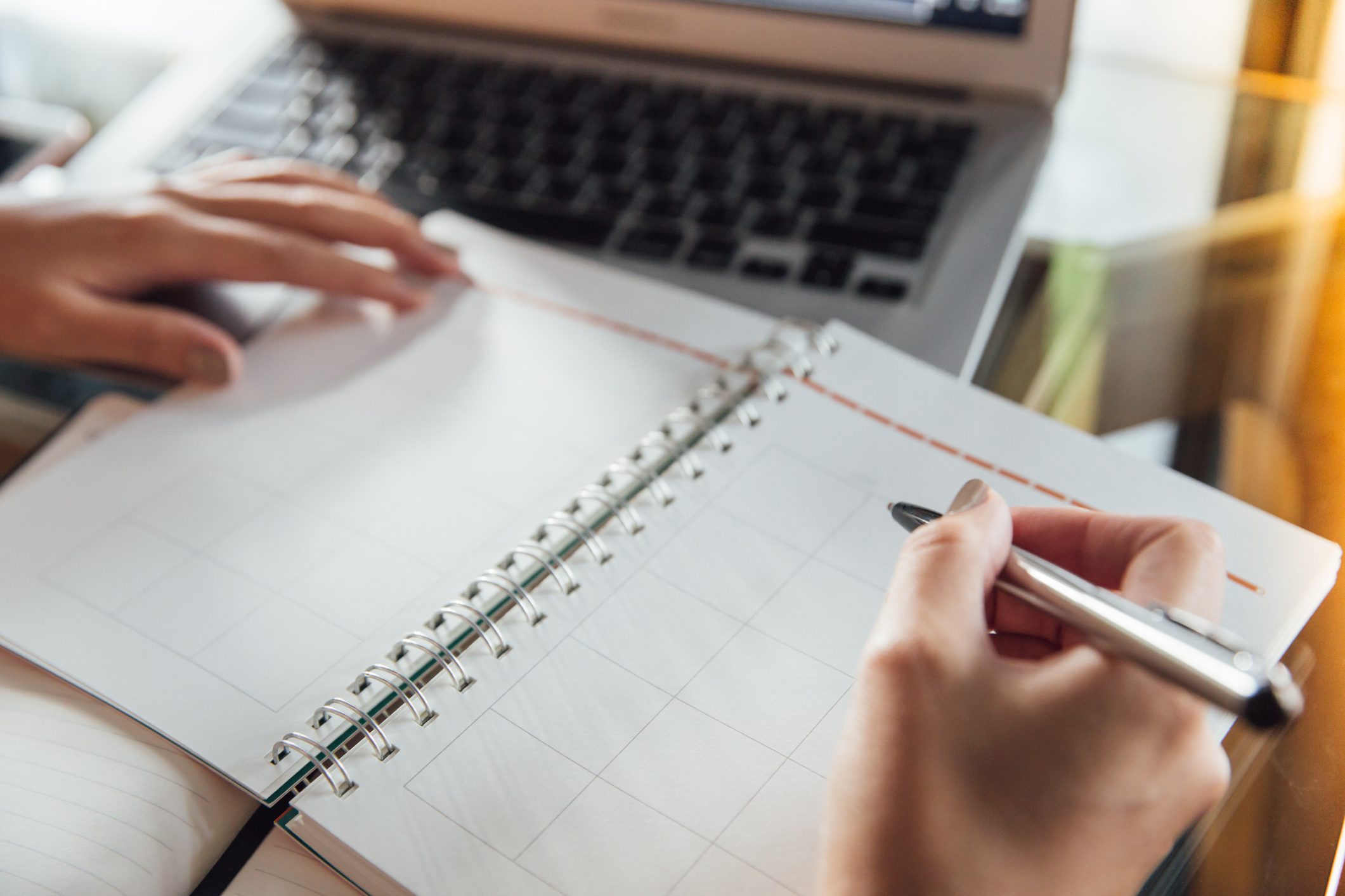 Writing in a datebook with a pen