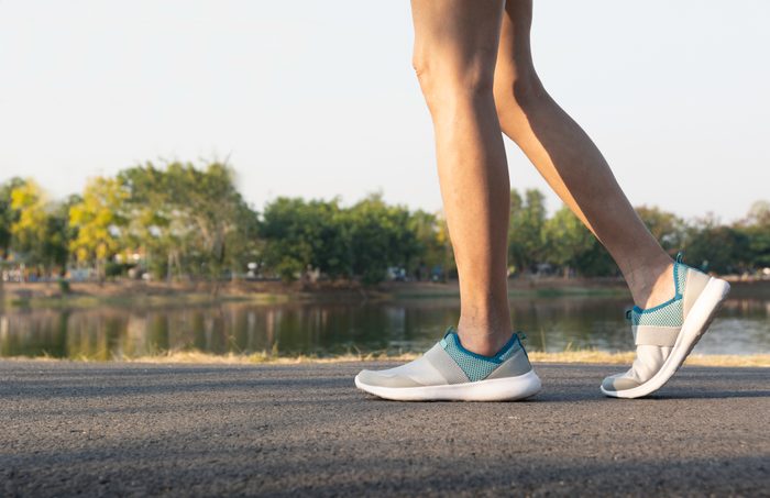 cropped low section of woman walking outside