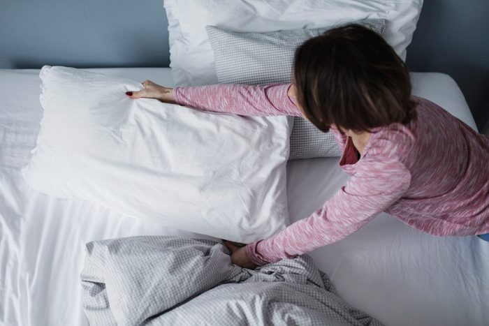 woman making bed