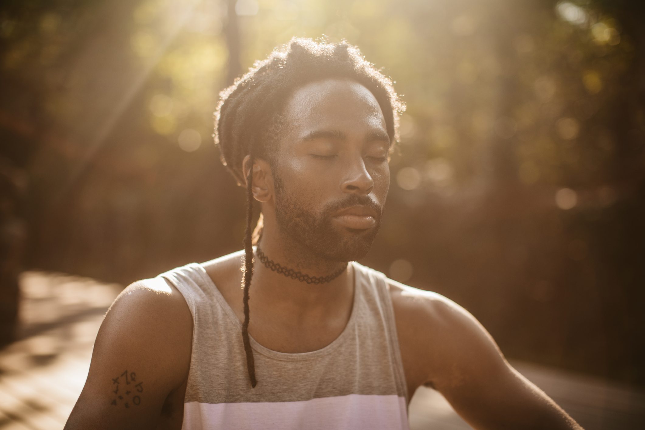 young man meditating outside