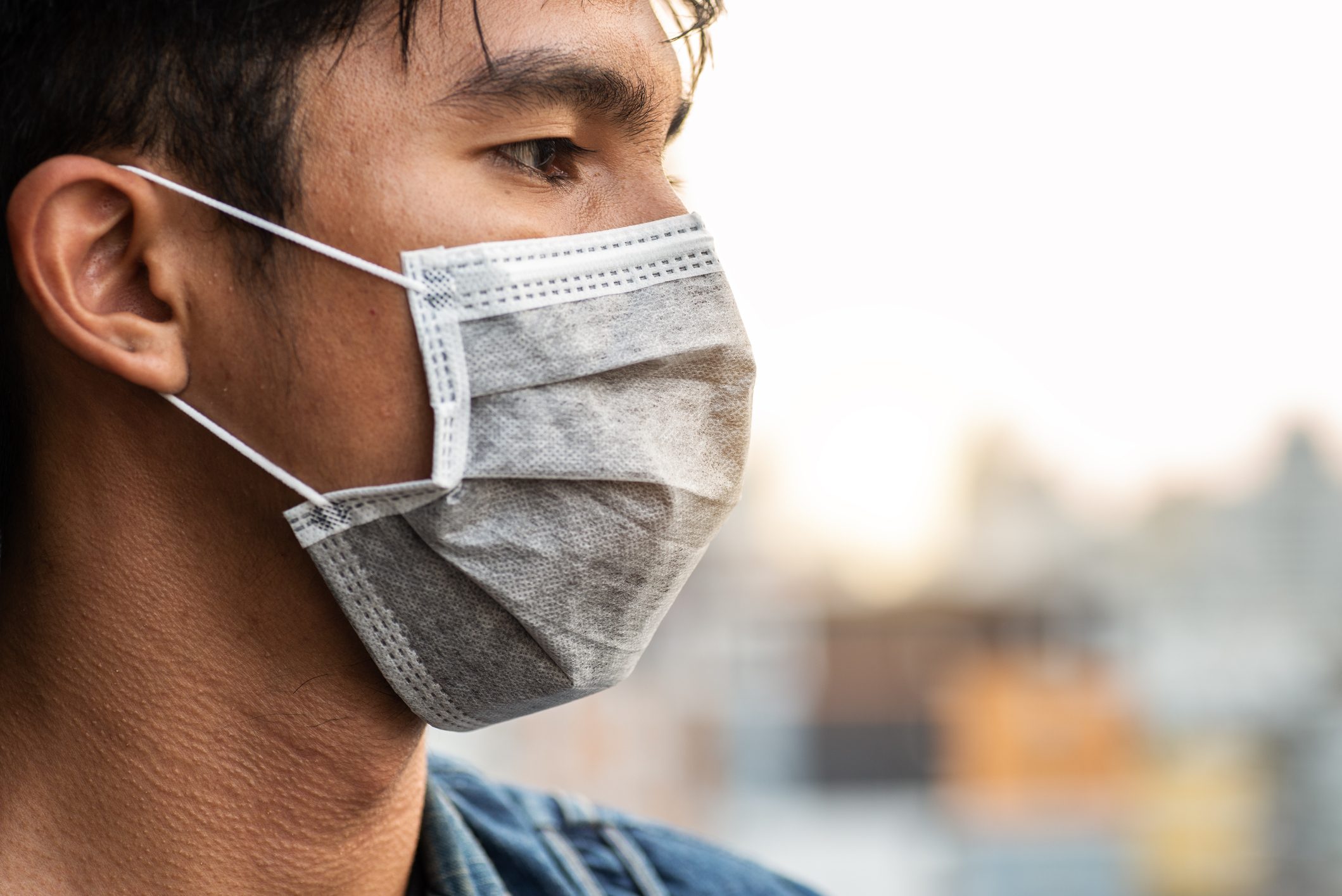 close up profile of man wearing a face mask