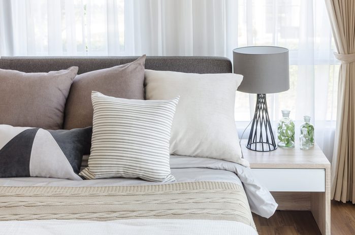 modern style bedroom with pillows on bed