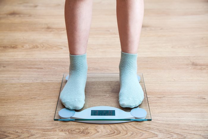 woman's feet standing on scale