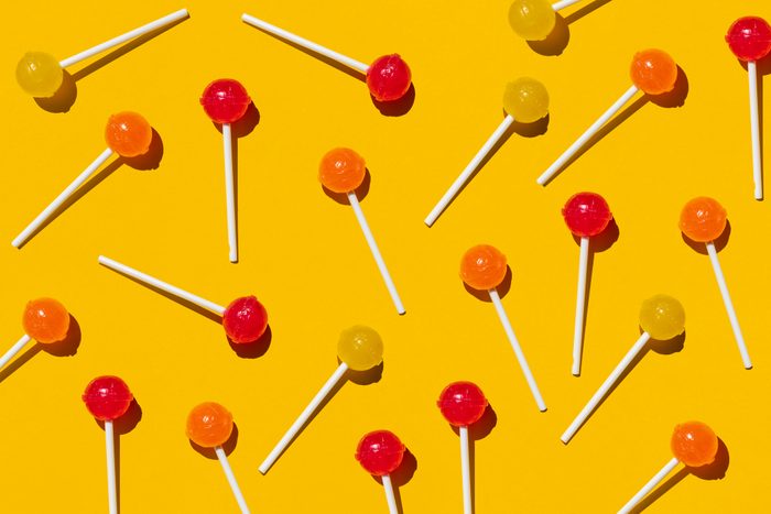 Pattern of lollipops against yellow background