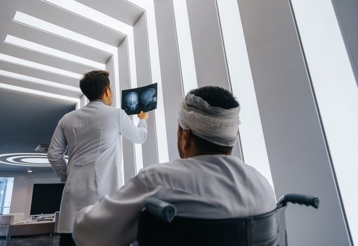 Young doctor man looking x-ray of the patient's skull