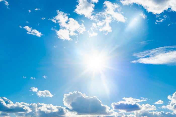 The sun shines brightly in the blue sky