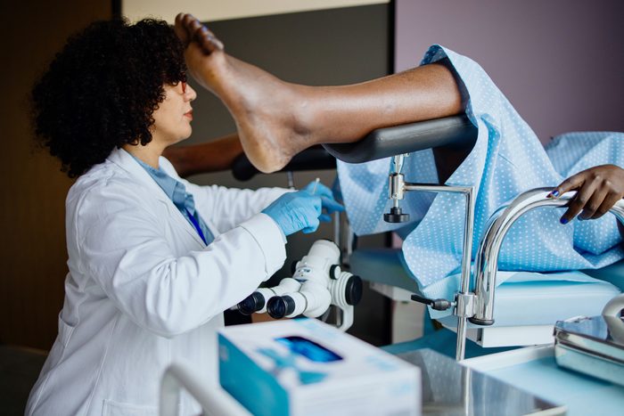 Female gynecologist doctor obtaining a cervical smear