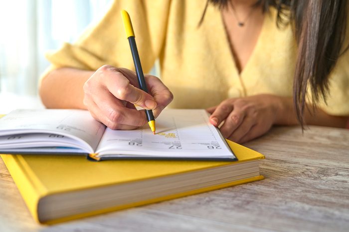 Woman writes on her datebook