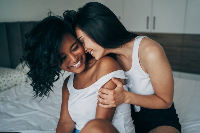 Two beautiful sexy women lesbian couple in the bed