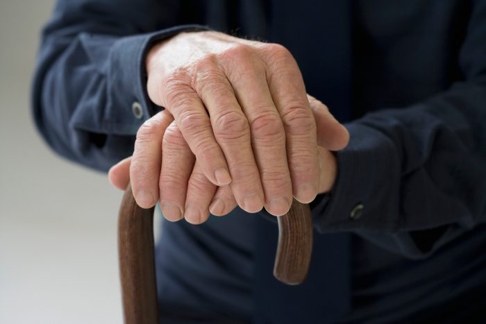 Close up of senior Hispanic man¿s hands on cane