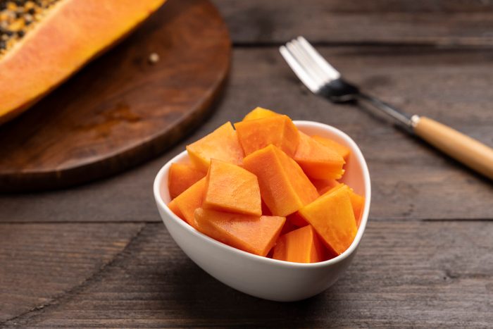 Sliced ripe papaya fruit on white plate ready to eat