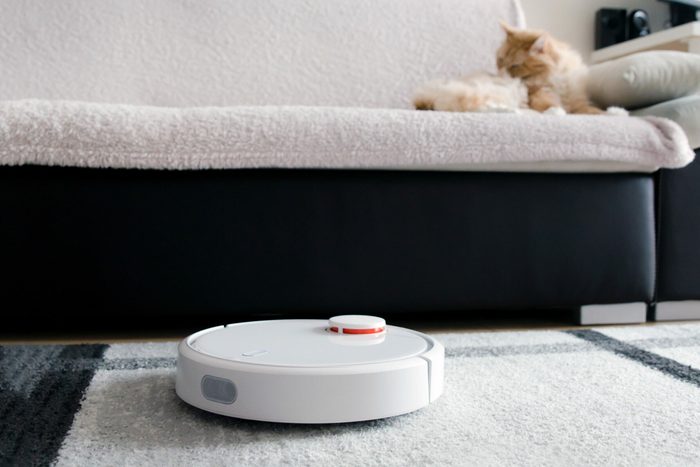 Robotic vacuum cleaner cleaning the room.
