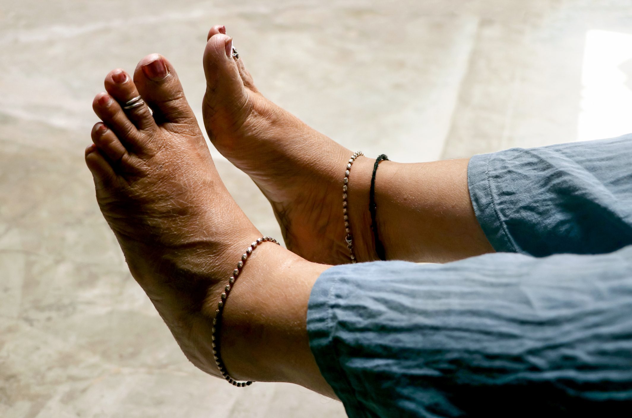 Closeup of an Indian woman's rough bare feet. Selective focus