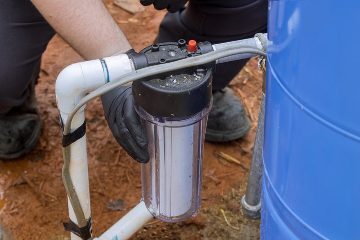 Maintenance worker replaces a filter at a domestic water treatment facility