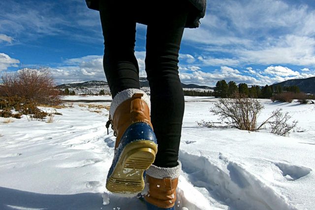 Walking On Snow With Winter Boots